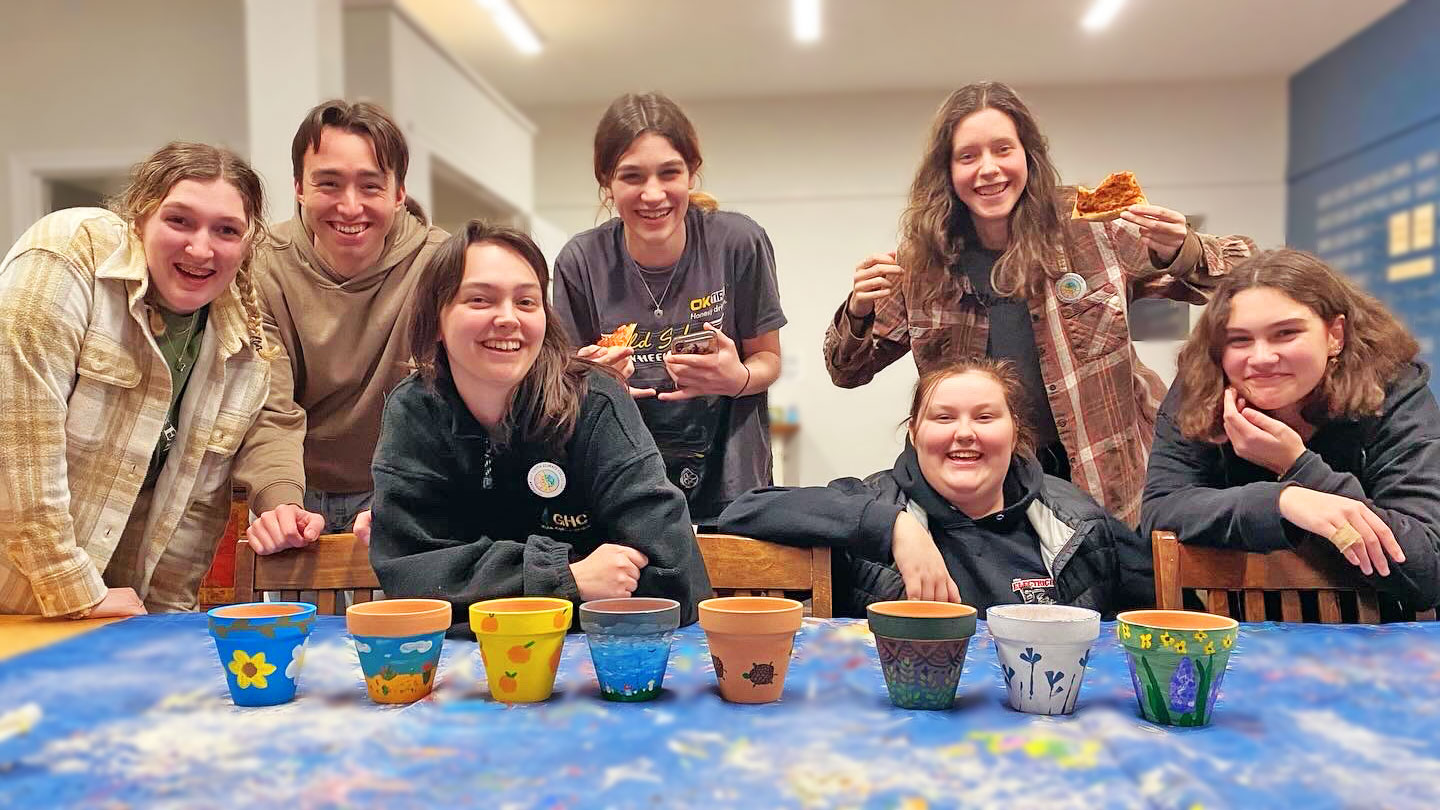 Multiple excited teenagers holding a banner that reads "Georgian Bay Youth Climate Collective"